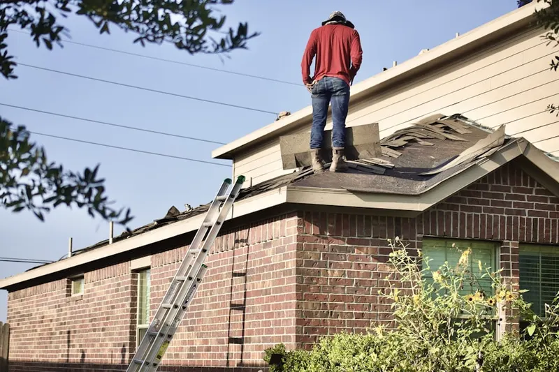Professional roofer working on a residential roof in North Virginia - Socrates